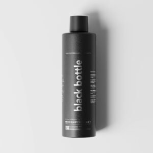 a bottle of black shampoo on a white surface
